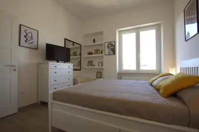 a bedroom with a bed and a television and a window at Sunny Flaminio Terrace Penthouse in Rome