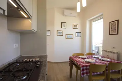 a kitchen with a table and a stove in a room at Sunny Flaminio Terrace Penthouse in Rome