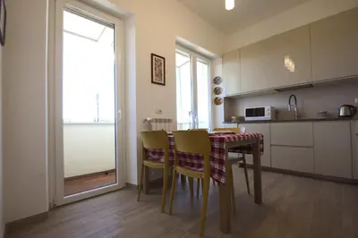 a kitchen with a table and chairs in a room at Sunny Flaminio Terrace Penthouse in Rome