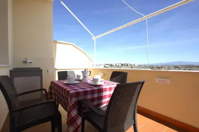 a table and chairs in a room with a large window at Sunny Flaminio Terrace Penthouse in Rome