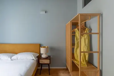 a bedroom with a bed and a wooden bookcase at iFlat The Monti Experience in Rome