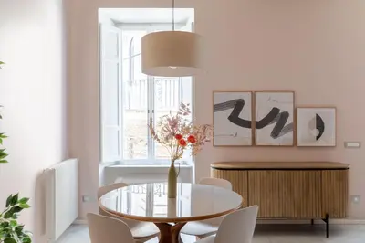 a dining room with a glass table and chairs at iFlat The Monti Experience in Rome