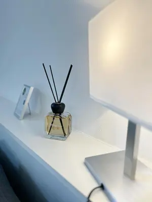 a vase with sticks in it sitting on a shelf at Life is Roma Termini in Rome