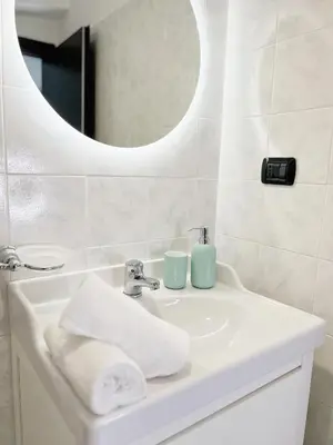 a bathroom sink with a mirror and a sink at Life is Roma Termini in Rome