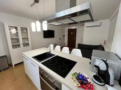 a kitchen and living room with a stove top oven at Life is Roma Termini in Rome