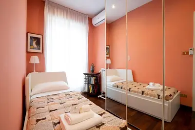 a bedroom with two beds and a mirror at La Terrazza di Paola San Giovanni in Rome