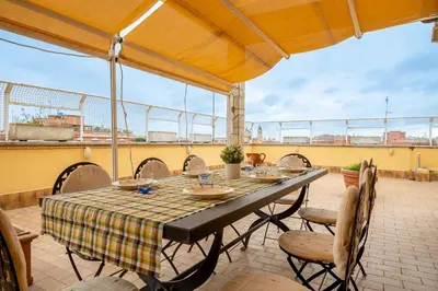 a table and chairs on a patio with a view at La Terrazza di Paola San Giovanni in Rome
