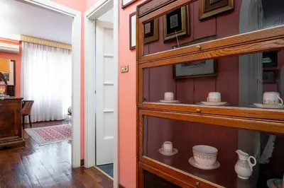 a shelf with cups and bowls on it in a room at La Terrazza di Paola San Giovanni in Rome