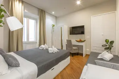 a bedroom with a bed and a desk with a computer at Farnese House in Rome