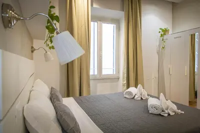 a bedroom with a bed with towels on it at Farnese House in Rome