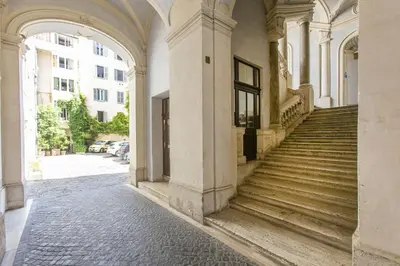 an old building with a staircase in a street at Farnese House in Rome