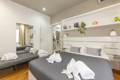 two beds in a room with white towels on them at Farnese House in Rome