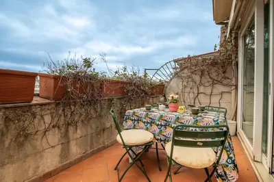 a table and chairs sitting on a balcony at Tiffany's apartment Flaminio in Rome