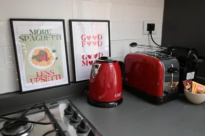 a kitchen counter with a toaster and pictures on the counter at Trastevere Boutique Apartment in Rome