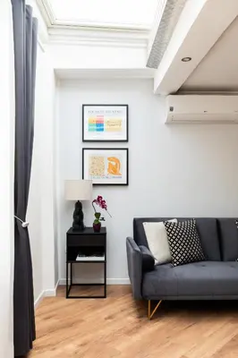 a living room with a couch and a table at Trastevere Boutique Apartment in Rome