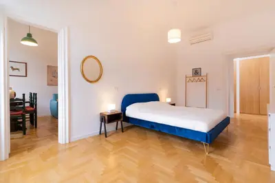 a bedroom with a bed and a dining room at Scipioni Holiday House in Rome