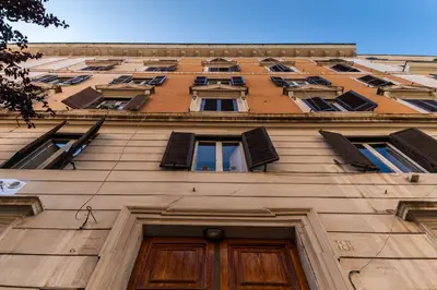 a tall building with many windows and a door at Scipioni Holiday House in Rome