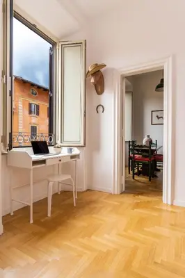 a room with a desk with a laptop on it at Scipioni Holiday House in Rome