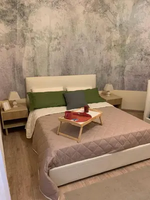 a bedroom with a bed with a table on it at Guest House VATICAN MUSEUMS PARVA DOMUS in Rome