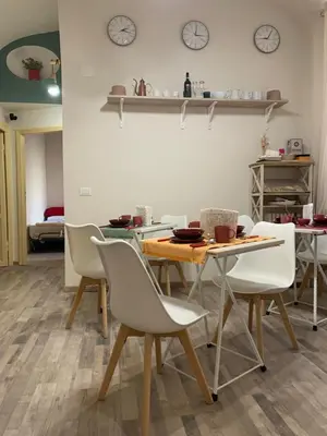 a dining room with a table and chairs and clocks at Guest House VATICAN MUSEUMS PARVA DOMUS in Rome