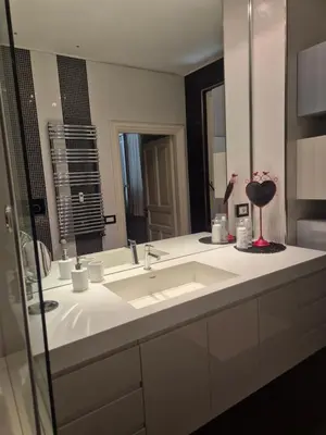 a bathroom with a sink and a large mirror at Attico Cavour Prati, vicino Piazza Navona, Castel Sant'Angelo e San Pietro in Rome