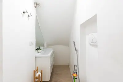 a white bathroom with a sink and a toilet at iFlat Cozy in Monti in Rome
