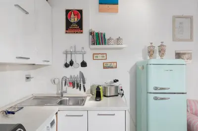 a kitchen with a sink and a refrigerator at iFlat Cozy in Monti in Rome