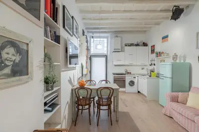 a kitchen and living room with a table and chairs at iFlat Cozy in Monti in Rome
