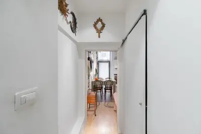 a hallway leading to a dining room with white walls at iFlat Cozy in Monti in Rome