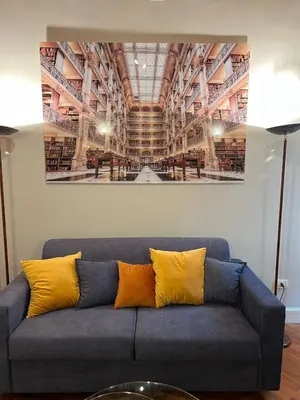 a blue couch with yellow pillows in a room at Artemide Domus Romae in Rome