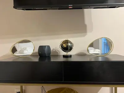 three mirrors on top of a black dresser at Artemide Domus Romae in Rome