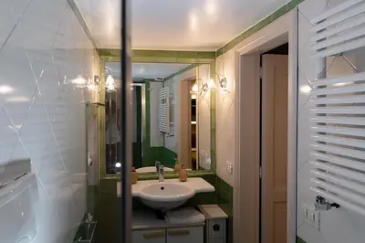a bathroom with a sink and a mirror at Artemide Domus Romae in Rome