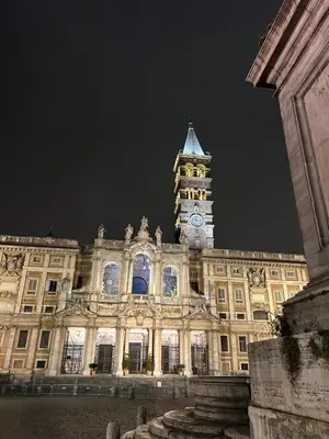 a large building with a clock tower at night at Dielle Apartments ROMA in Rome