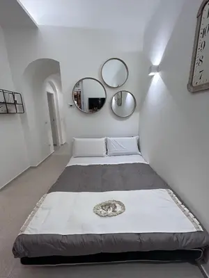 two beds in a room with two mirrors at A CASA DEI ROMANI in Rome