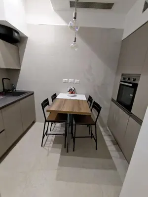 a kitchen with a wooden table and chairs at A CASA DEI ROMANI in Rome