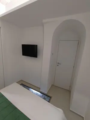 a white room with a television and a door at A CASA DEI ROMANI in Rome