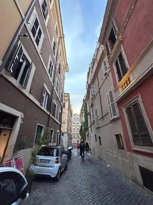 a group of people walking down a street with buildings at A CASA DEI ROMANI in Rome