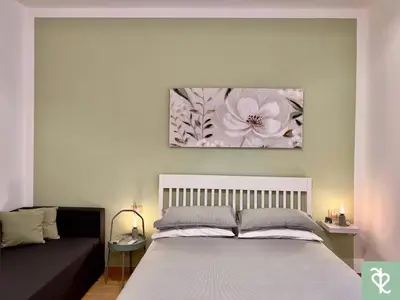 a bedroom with a bed and a couch at RomeSweetRome in Rome