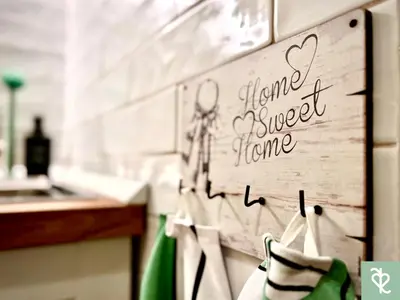 a kitchen with a sign that says tune nicer home at RomeSweetRome in Rome