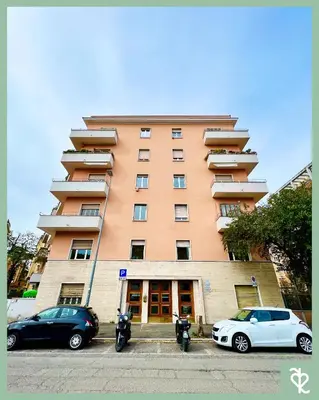 two cars parked in front of a tall building at RomeSweetRome in Rome