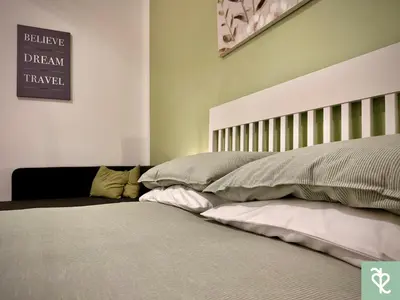a bedroom with a bed and a sign on the wall at RomeSweetRome in Rome