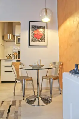 a dining room with a table and two chairs at Sophisticated Studio Decor in Rome