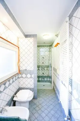 a bathroom with a toilet and a sink and a shower at Blue Navona Two Bedroom Apartment in Rome