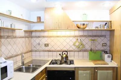 a kitchen with a sink and a stove top oven at Blue Navona Two Bedroom Apartment in Rome