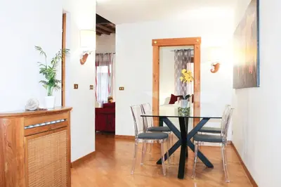 a dining room with a black table and chairs at Blue Navona Two Bedroom Apartment in Rome