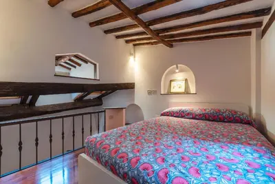 a bedroom with a bed in a room with wooden ceilings at Trastevere Escape - Charme Holidays in Rome