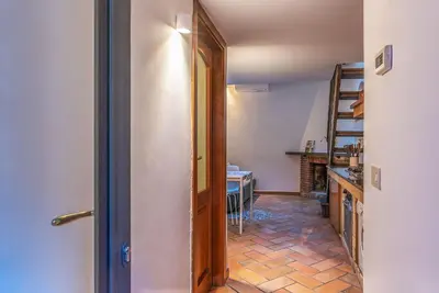 a hallway leading to a kitchen with a table at Trastevere Escape - Charme Holidays in Rome