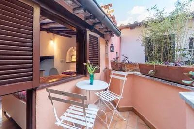 a small balcony with a table and two chairs at Trastevere Escape - Charme Holidays in Rome