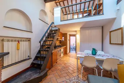 a kitchen and dining room with a spiral staircase at Trastevere Escape - Charme Holidays in Rome