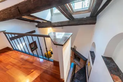 an attic hallway with a staircase with wooden beams at Trastevere Escape - Charme Holidays in Rome